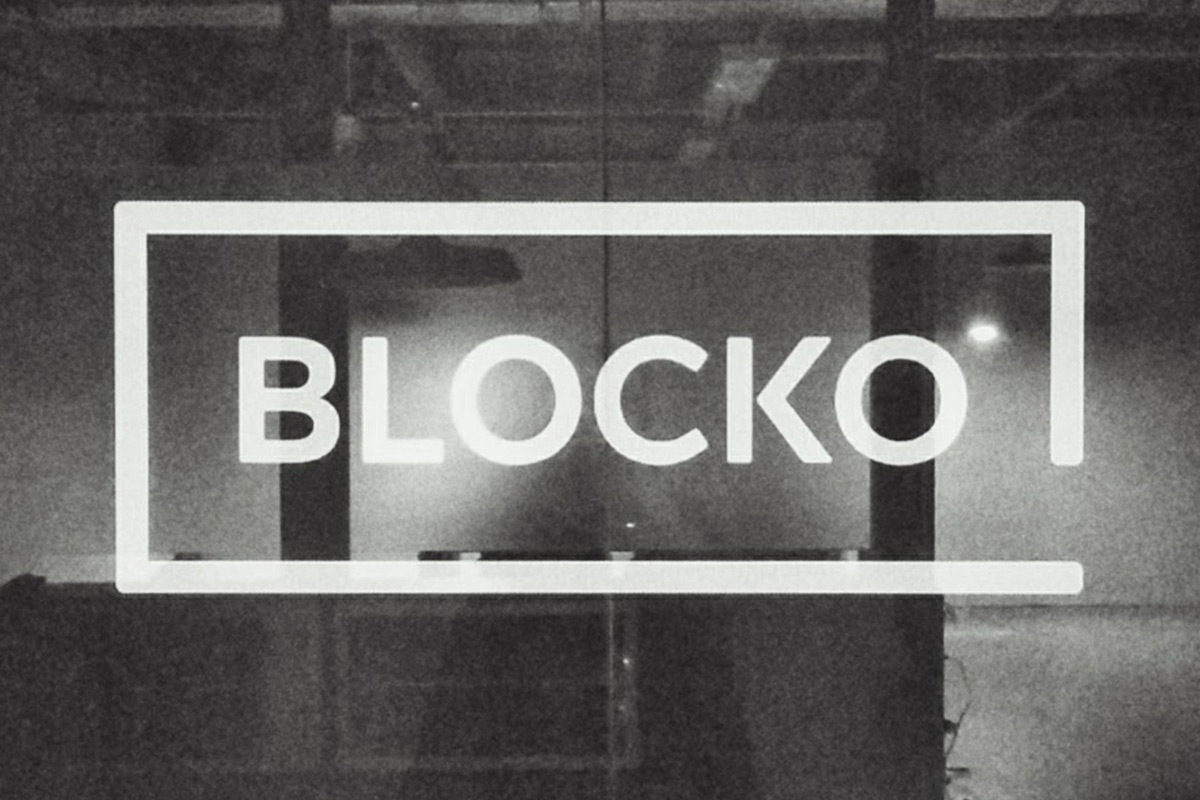 Black and white picture of a glass wall with a bit typographic logo that says "Blocko"