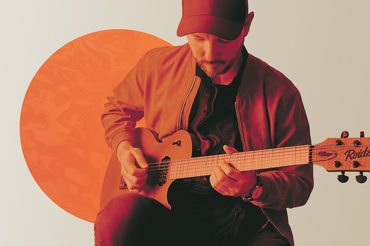 Picture of Victor playing guitar. Promotional art for This Is Mars.