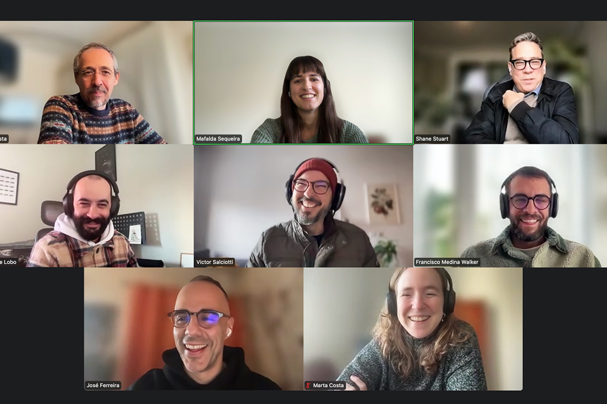 A zoom call with 8 people in total. Everyone is smilling.